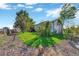 Large backyard with mature trees, grassy area, and raised garden beds at 2460 Eileen Way, Parker, CO 80138