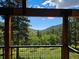 Deck overlooks scenic mountain views and lush greenery at 6474 Lone Eagle Rd, Golden, CO 80403
