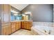 Double vanity bathroom with corner bathtub at 6474 Lone Eagle Rd, Golden, CO 80403