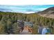 Log home and garage nestled in a mountain forest setting at 6474 Lone Eagle Rd, Golden, CO 80403