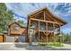 Two-story home with a large deck and attached garage; mountain setting at 6474 Lone Eagle Rd, Golden, CO 80403
