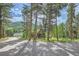 Rustic log home nestled in a wooded mountain setting with a large yard at 6474 Lone Eagle Rd, Golden, CO 80403