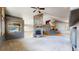 Living room with a stone fireplace and view to kitchen at 6474 Lone Eagle Rd, Golden, CO 80403