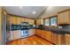 Kitchen with wood cabinets, granite countertops and stainless steel appliances at 6474 Lone Eagle Rd, Golden, CO 80403