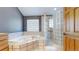 Bathroom with glass shower and corner bathtub at 6474 Lone Eagle Rd, Golden, CO 80403