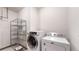 Laundry room with washer, dryer, and shelving unit at 6474 Lone Eagle Rd, Golden, CO 80403