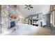 Open living area featuring a large stone fireplace and vaulted ceilings at 6474 Lone Eagle Rd, Golden, CO 80403