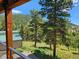 Deck view of a green metal building and mountain landscape at 6474 Lone Eagle Rd, Golden, CO 80403