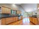 Modern kitchen with wood cabinets, granite counters, and stainless steel appliances at 6474 Lone Eagle Rd, Golden, CO 80403