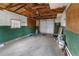 Unfinished garage with exposed wood beams and green walls at 1100 S Quitman St, Denver, CO 80219