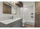 Updated bathroom with gray vanity, marble tile, and bathtub at 12100 Huron St # 201, Denver, CO 80234