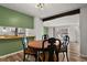 Bright dining area with wood table and chairs, adjacent to kitchen at 12100 Huron St # 201, Denver, CO 80234