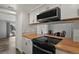 Modern kitchen with butcher block countertops and appliances at 12100 Huron St # 201, Denver, CO 80234