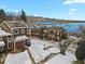 Aerial view of townhouses near a lake, snowy landscape, and mountains in the background at 14585 W 32Nd Ave, Golden, CO 80401