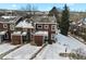 Aerial view of a brown townhouse community in a snowy landscape at 14585 W 32Nd Ave, Golden, CO 80401