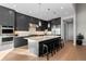 Modern kitchen featuring dark cabinetry, stainless steel appliances, and a large island with seating at 1192 Lost Elk Loop, Castle Rock, CO 80108