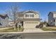 Two-story house with beige siding, attached garage, and landscaped lawn at 9605 Elk Mountain Cir, Littleton, CO 80125