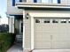 Beige house exterior featuring an attached garage and front entrance at 9605 Elk Mountain Cir, Littleton, CO 80125