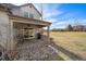 Private patio with stone pathway, grill, and seating area, overlooking a golf course at 2181 S Victor St # D, Aurora, CO 80014