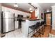 Modern kitchen with white cabinets, stainless steel appliances, and a breakfast bar at 2438 W 35Th Ave # 2, Denver, CO 80211