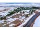 Aerial view of a snowy lot with a road and some trees at 7 Canyon Pines Dr, Arvada, CO 80403