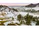 Aerial view of a snow covered landscape with roads and trees at 7 Canyon Pines Dr, Arvada, CO 80403