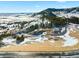 Aerial view of a snowy lot with mountain in background at 7 Canyon Pines Dr, Arvada, CO 80403