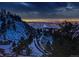 Night view of a city landscape with glowing lights and snow at 7 Canyon Pines Dr, Arvada, CO 80403