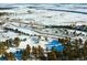 Aerial view of a snowy landscape and road at 7 Canyon Pines Dr, Arvada, CO 80403