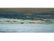 Night aerial view of snowy landscape with city lights in the distance at 7 Canyon Pines Dr, Arvada, CO 80403