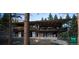 Modern two-story home nestled in the woods with expansive deck at 7 Canyon Pines Dr, Arvada, CO 80403