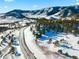 Aerial view of a snow covered property with mountainous background at 7 Canyon Pines Dr, Arvada, CO 80403