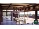 Open concept living space with a large dining table and fireplace at 7 Canyon Pines Dr, Arvada, CO 80403