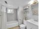 Simple bathroom with shower/tub, vanity, and window at 2450 S Deframe St, Lakewood, CO 80228