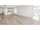 Open living room featuring wood-like floors and an open concept kitchen at 9280 Bahama Ct, Commerce City, CO 80022