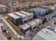 Aerial view of four modern townhomes with attached garages at 3275 Lawrence St, Denver, CO 80205