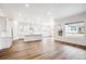 Modern kitchen with white cabinets, large island, and stainless steel appliances at 5451 Riverbend Ave, Firestone, CO 80504