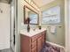 Clean bathroom with wood vanity and a mirror at 824 S Nelson Way, Lakewood, CO 80226