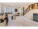 Bright living room with bay window, comfy seating, and a view to the hallway at 824 S Nelson Way, Lakewood, CO 80226