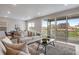 Bright living room with sliding glass doors leading to a deck and backyard at 13351 E 100Th Pl, Commerce City, CO 80022