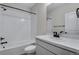 Clean bathroom with a white tiled shower, bathtub and vanity at 13351 E 100Th Pl, Commerce City, CO 80022
