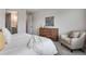 Main bedroom with cozy sitting area and dresser at 13351 E 100Th Pl, Commerce City, CO 80022