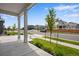 Front porch view of a quiet residential street with houses and trees at 13351 E 100Th Pl, Commerce City, CO 80022