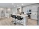Modern kitchen with white cabinets, stainless steel appliances, and an island with seating at 13351 E 100Th Pl, Commerce City, CO 80022