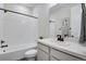 Clean bathroom with a white tiled shower, bathtub and vanity at 13351 E 100Th Pl, Commerce City, CO 80022