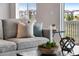 Cozy living room with gray couch and end table with decor at 13351 E 100Th Pl, Commerce City, CO 80022