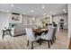 Open concept dining area with modern light fixtures and hardwood floors at 13351 E 100Th Pl, Commerce City, CO 80022
