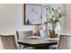 Square dining table with seating for four in a bright dining area at 13351 E 100Th Pl, Commerce City, CO 80022