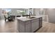 Modern kitchen island with white quartz countertops and stainless steel appliances at 13351 E 100Th Pl, Commerce City, CO 80022