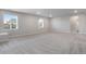 Large unfinished basement with neutral carpeting and natural light at 13351 E 100Th Pl, Commerce City, CO 80022